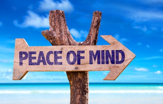 peace of mind beach sign in the sand